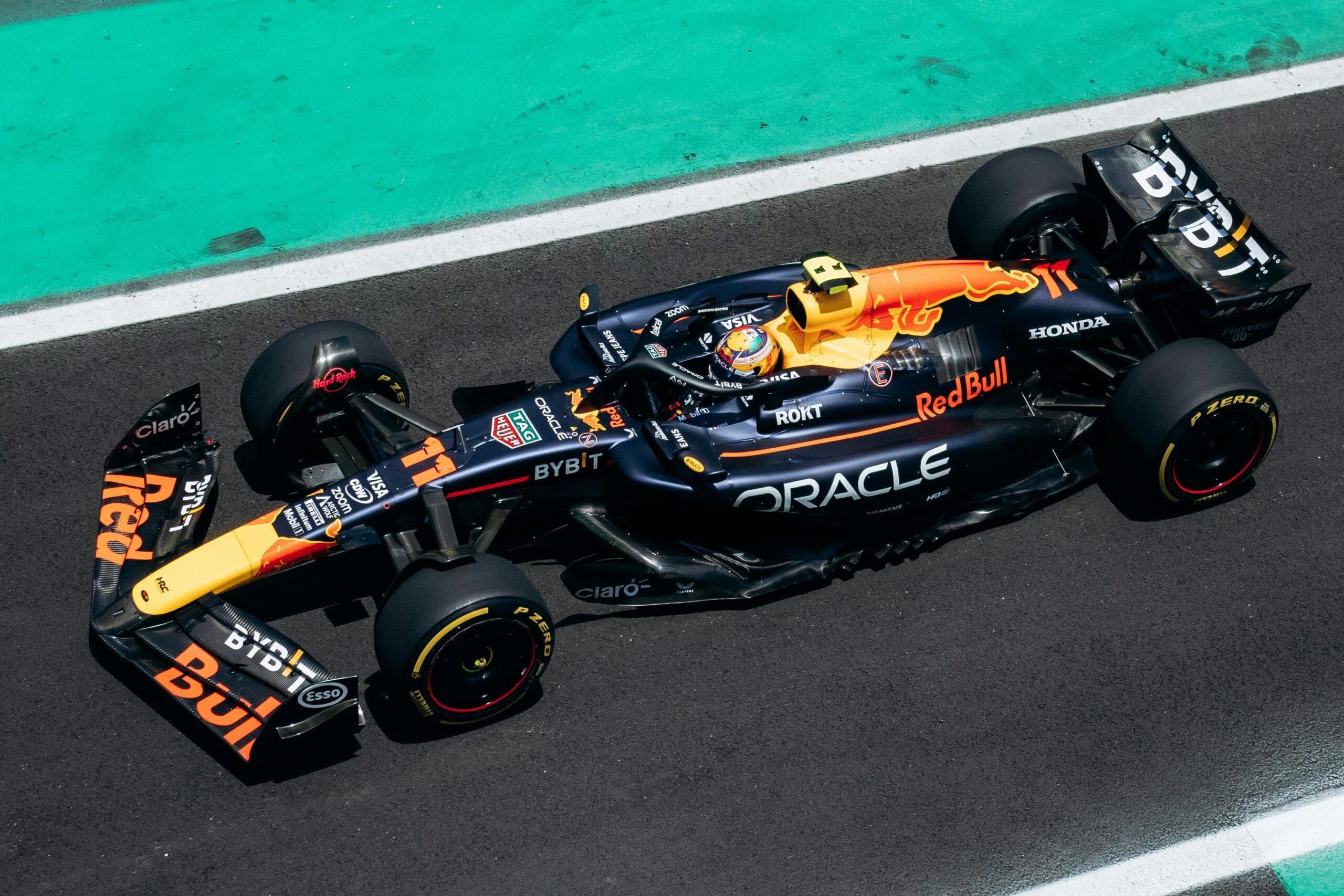 A dynamic shot of a red Formula 1 car speeding on the race track, showcasing racing energy.