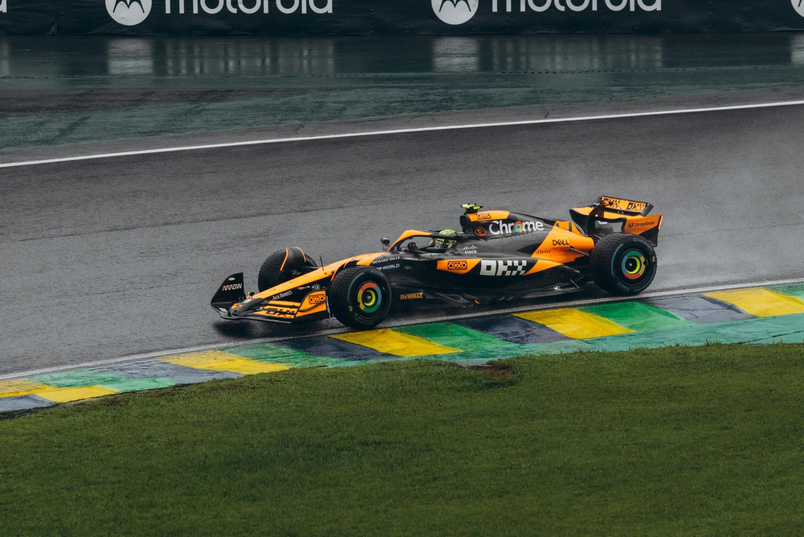 A dynamic shot of a red Formula 1 car speeding on the race track, showcasing racing energy.