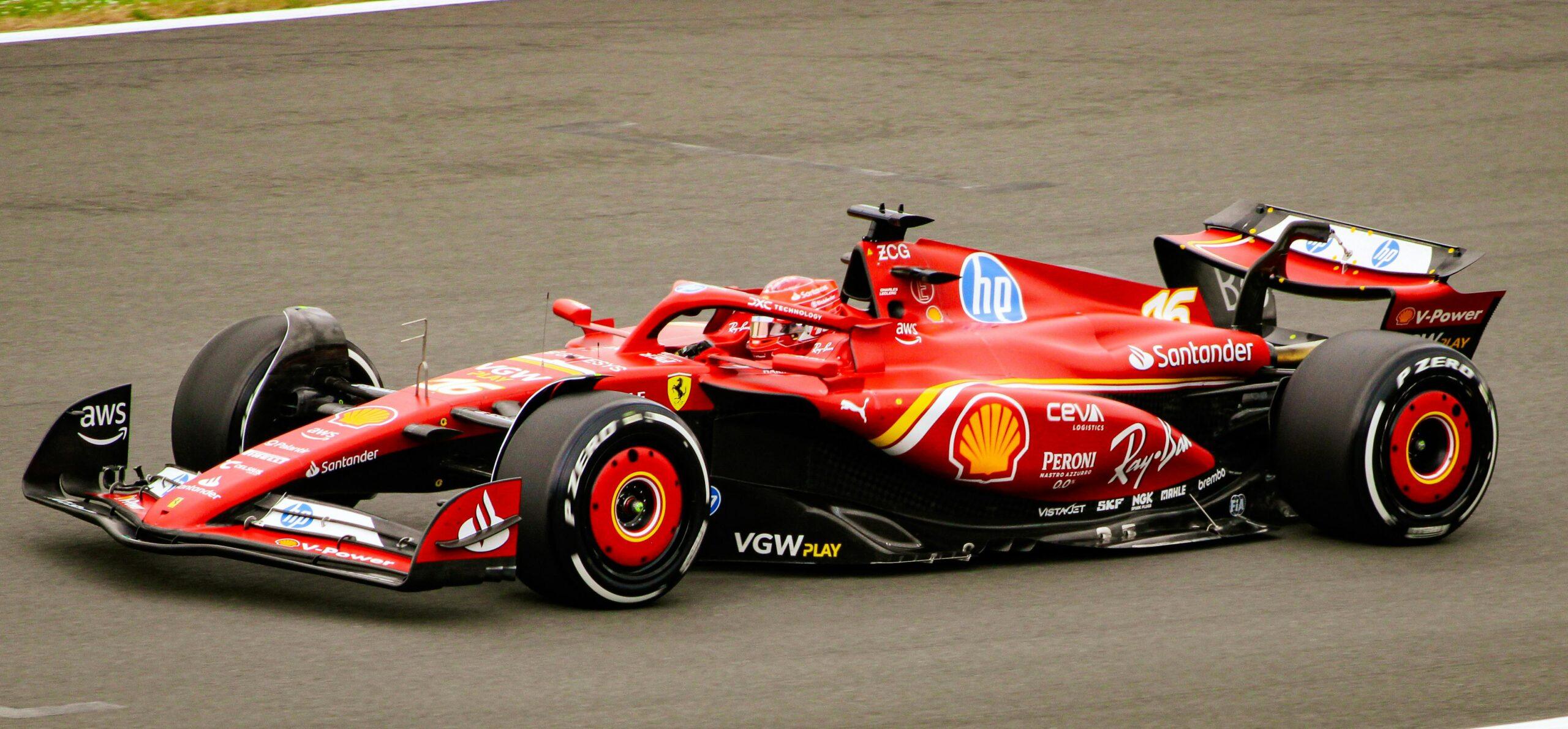 A dynamic shot of a red Formula 1 car speeding on the race track, showcasing racing energy.