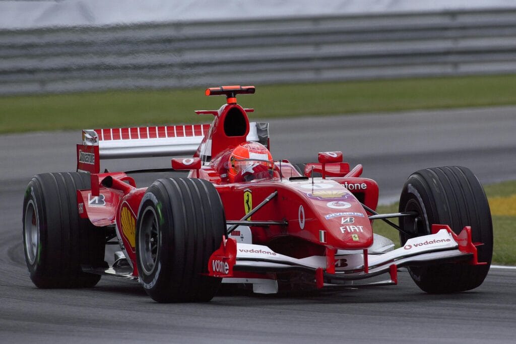 INICIO Ferrari Formula 1 car racing at high speed on the Indianapolis track, showcasing motorsport excitement.